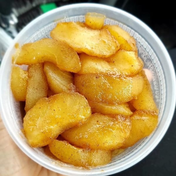 Cafe Curbside's warm cinnamon-spiced apple slices in a clear plastic container.
